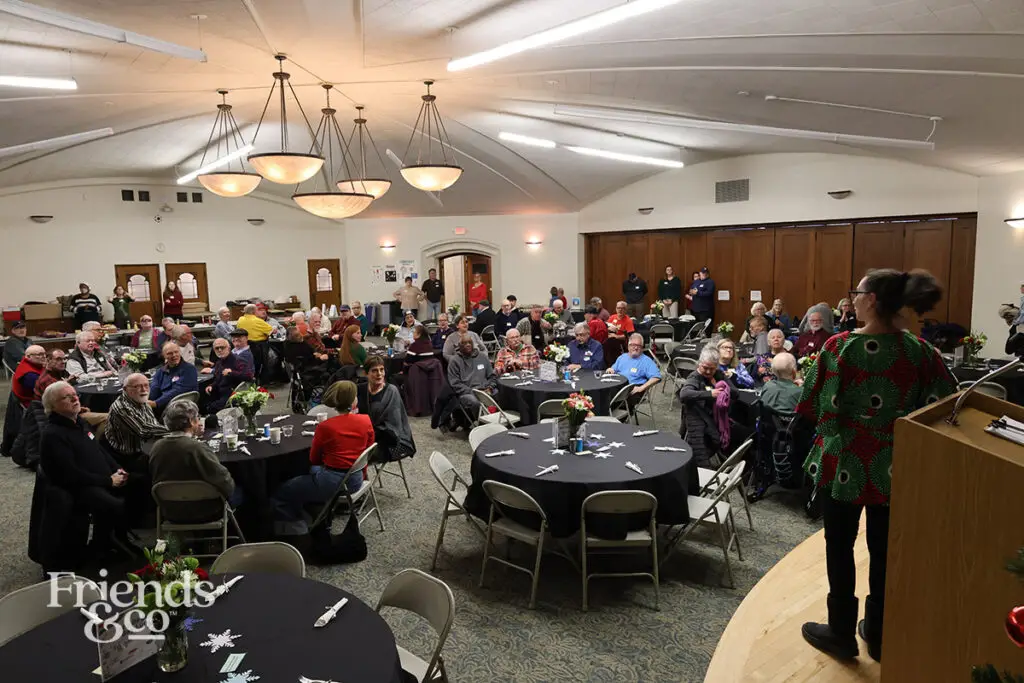 A room full of elderly older adults at Friends & Co queer holiday luncheon for older adults in the Twin Cities 2025