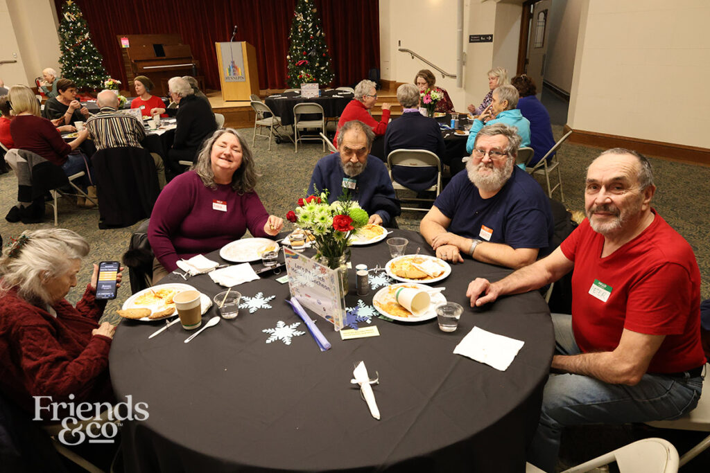 a happy group of elders at Friends & Co queer holiday luncheon for older adults in the Twin Cities 2025