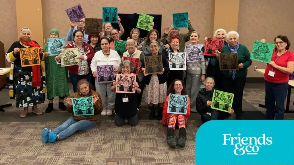 Participants showing their art made with COMPAS Teaching Artist Constanza Carballon at Friends & Co Cafe Y Conversaciones