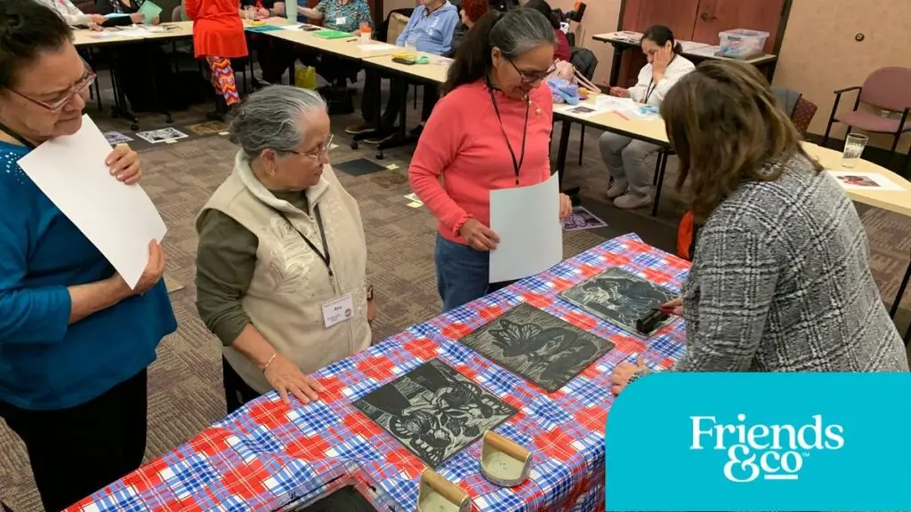 COMPAS Teaching Artist Constanza Carballon demonstrates print making at Friends & Co Cafe Y Conversaciones
