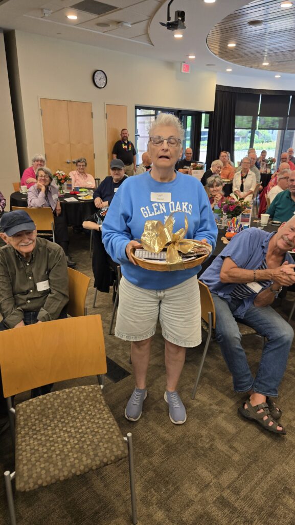 Lesbian Older adult holding his winning themed gift basket