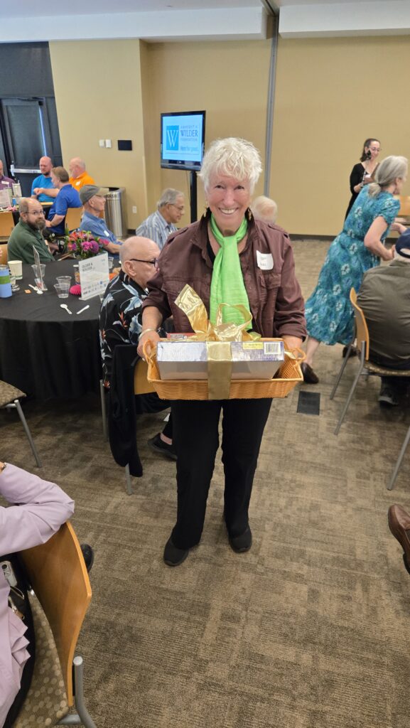 Smiling Older adult holding his winning themed gift basket