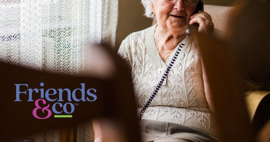 An older adult on the phone, Friends & Co logo in the bottom left hand corner of image