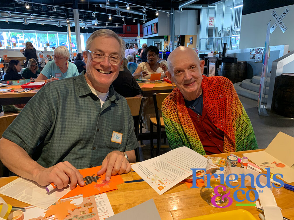 Volunteers at Rail Werks Brewing Company smiling at the camera during a handmade cardmaking event